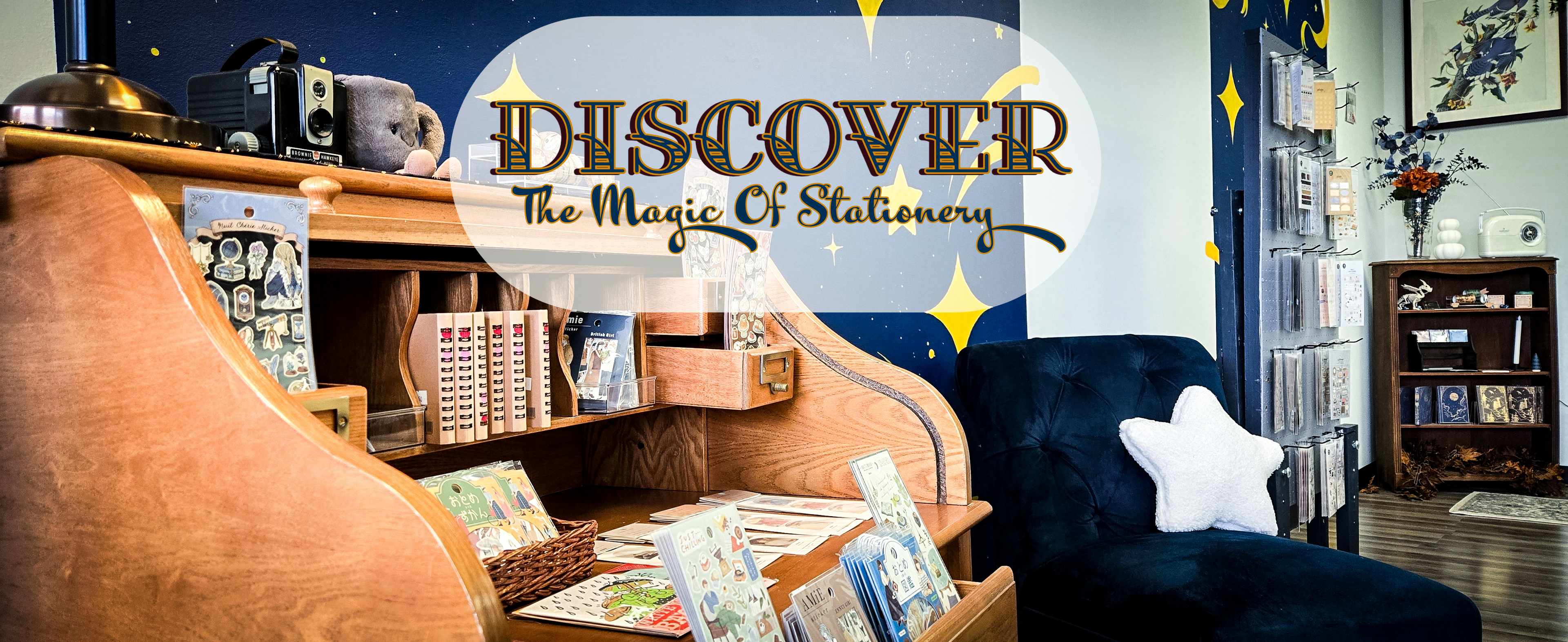 Papel Arcano shop interior with antique desk displaying sticker sheets -- headline reads 'Discover the Magic of Stationery'